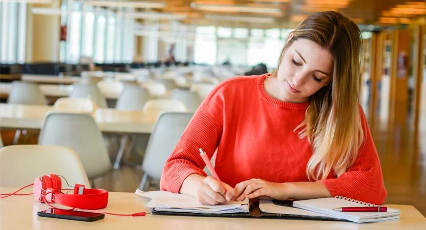 She is writing notes on how to enter stocks with voucher in Company 2.