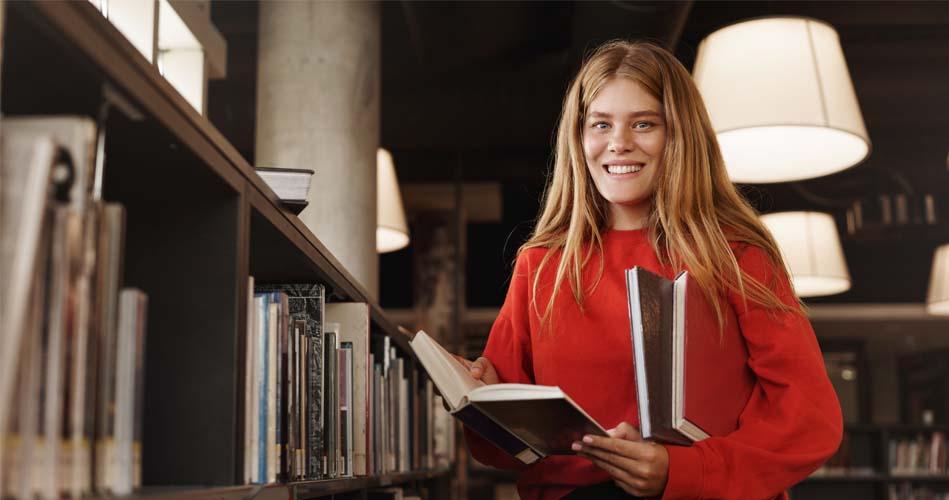 Girl grabbing some books regarding Swift course